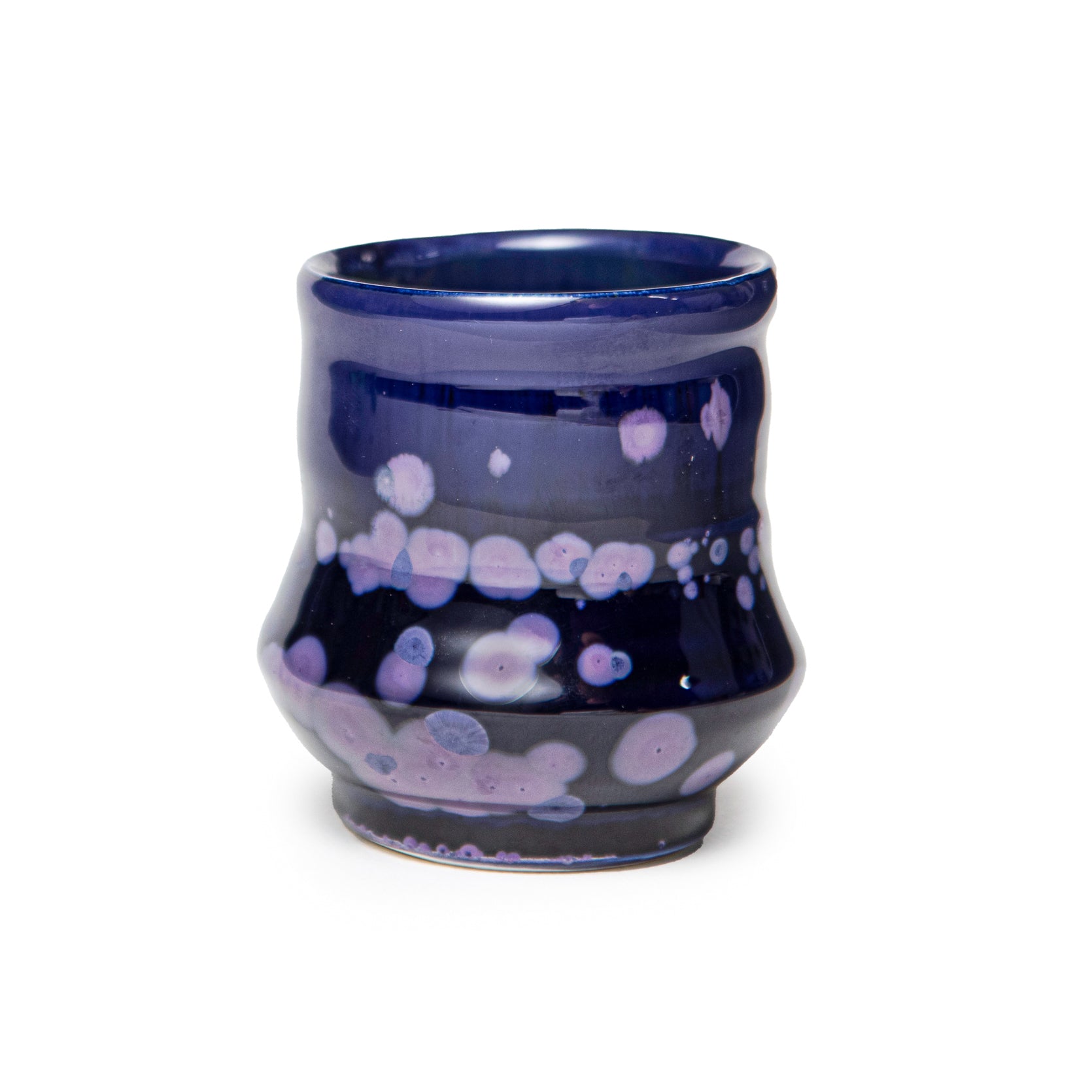 Ceramic cup with blue and purple glaze on a white background