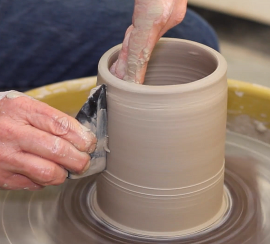 John Britt working with clay on a pottery wheel